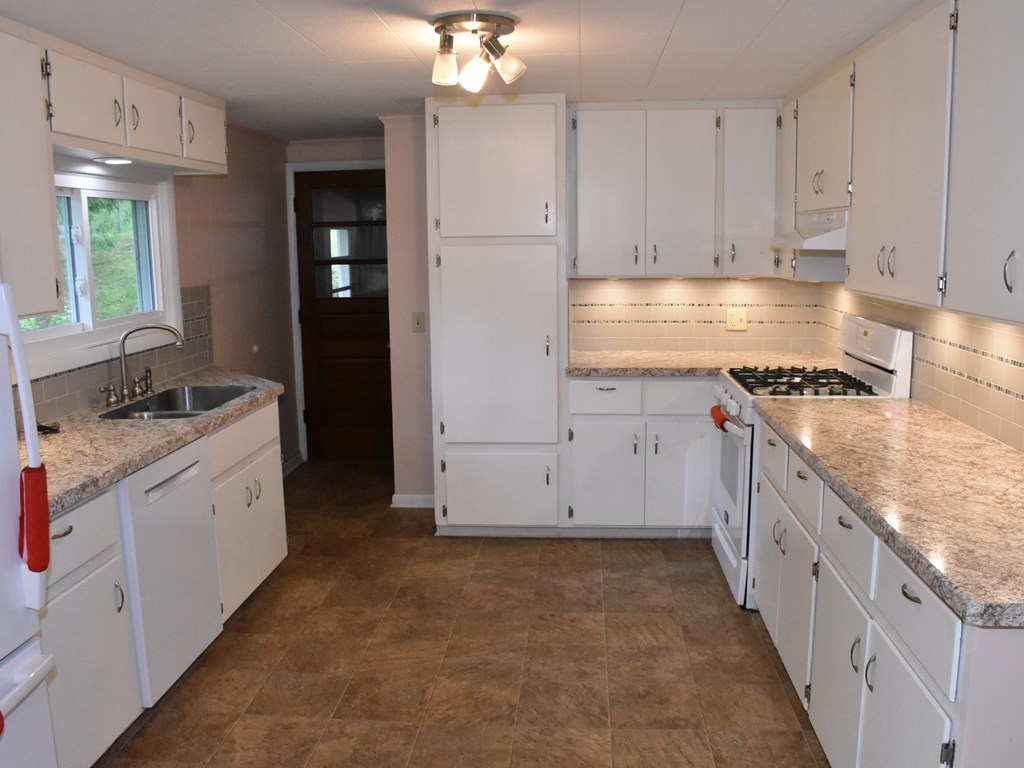 16475 Harmonsburg Road Meadville, PA 16335 - Photo 11 of 35 a kitchen with granite countertop a stove and a sink