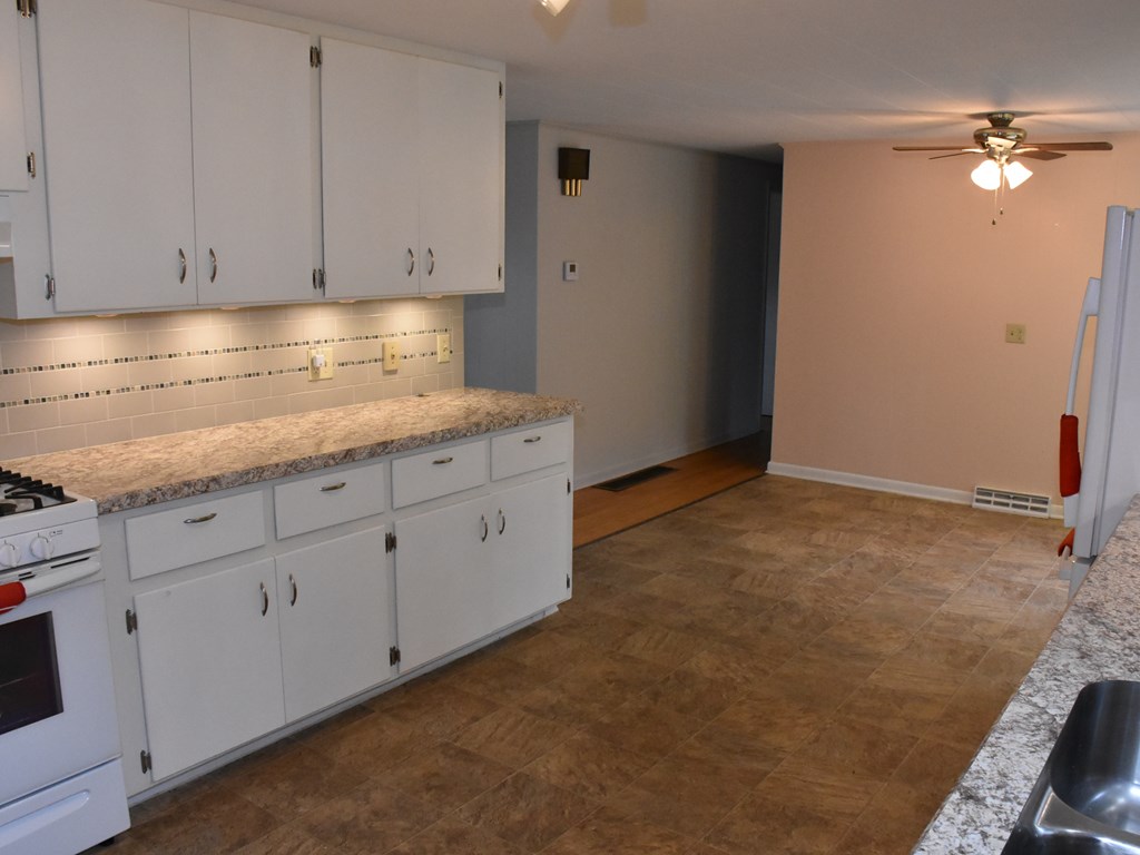 16475 Harmonsburg Road Meadville, PA 16335 - Photo 12 of 35 a kitchen with granite countertop white cabinets and stainless steel appliances