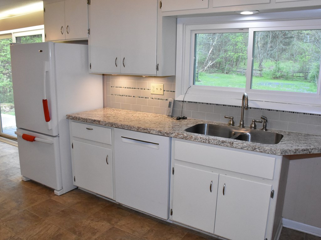 16475 Harmonsburg Road Meadville, PA 16335 - Photo 13 of 35 a kitchen with granite countertop a sink window and cabinets