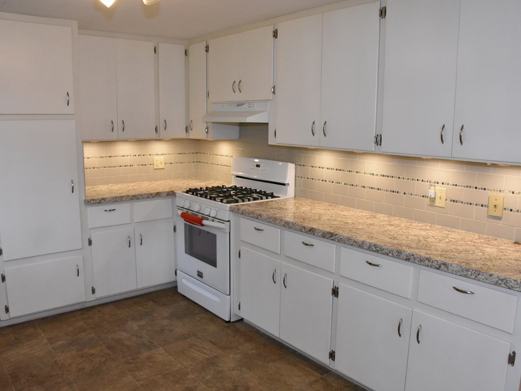 16475 Harmonsburg Road Meadville, PA 16335 - Photo 15 of 35 a kitchen with granite countertop white cabinets and white appliances