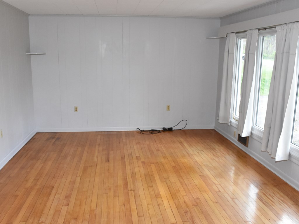 16475 Harmonsburg Road Meadville, PA 16335 - Photo 7 of 35 an empty room with wooden floor and windows