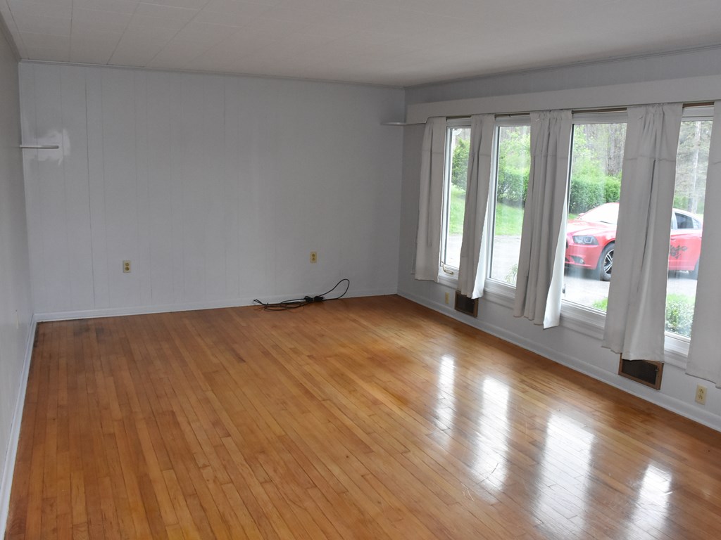16475 Harmonsburg Road Meadville, PA 16335 - Photo 9 of 35 a view of an empty room with wooden floor and a window