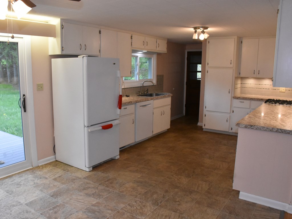 16475 Harmonsburg Road Meadville, PA 16335 - Photo 10 of 35 a kitchen with refrigerator and cabinets