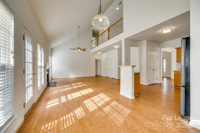 a view of a hallway with a dining table & chairs