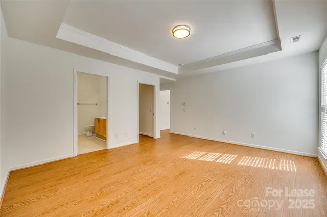 a spacious bathroom with a granite countertop sink mirror and a toilet