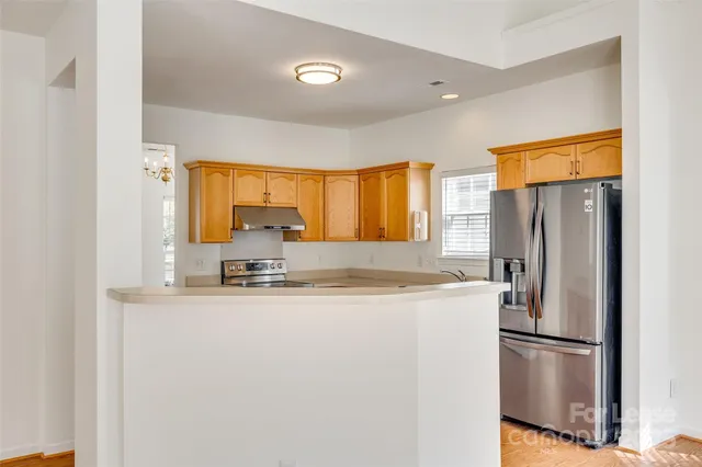 a kitchen with stainless steel appliances a refrigerator and a stove