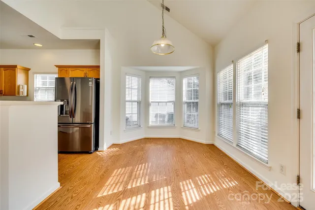 a kitchen with stainless steel appliances granite countertop a refrigerator a sink and a stove