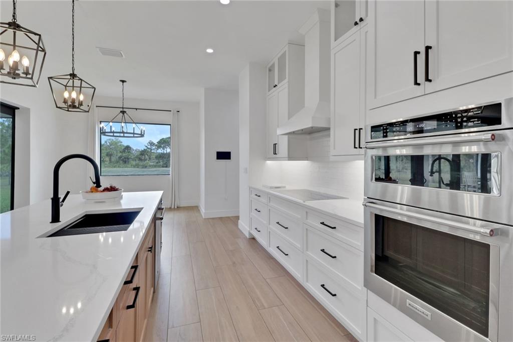 3748 Everglades Boulevard North Naples, FL 34120 - Photo 13 of 49 a kitchen with stainless steel appliances granite countertop a stove and a sink