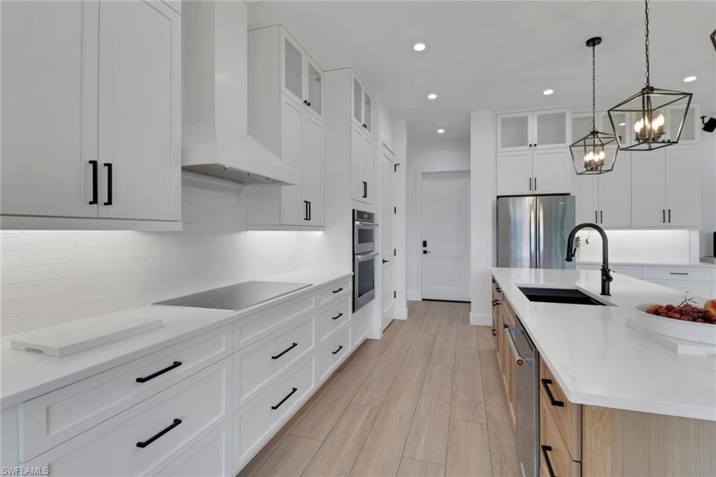 3748 Everglades Boulevard North Naples, FL 34120 - Photo 15 of 49 a kitchen with stainless steel appliances granite countertop a sink a stove and a refrigerator