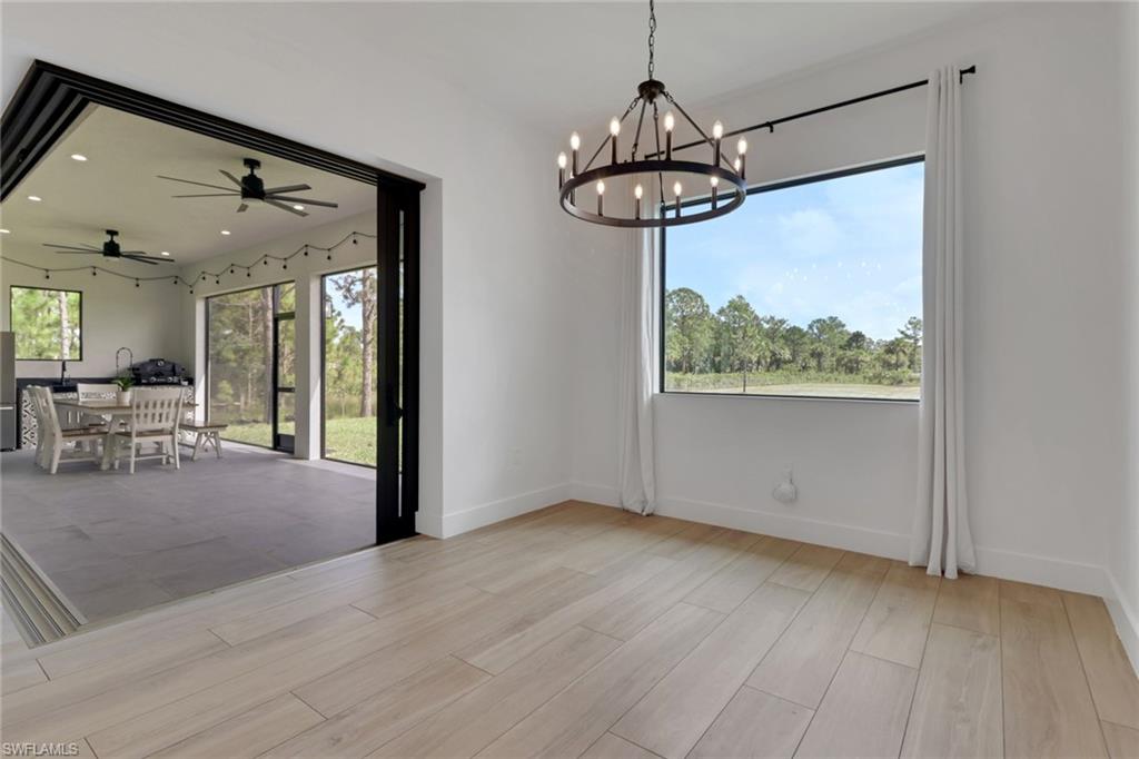 3748 Everglades Boulevard North Naples, FL 34120 - Photo 17 of 49 a view of a livingroom with furniture wooden floor and chandelier