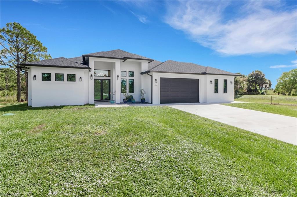 3748 Everglades Boulevard North Naples, FL 34120 - Photo 2 of 49 a front view of house with yard and green space