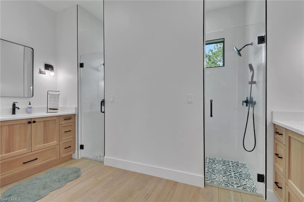 3748 Everglades Boulevard North Naples, FL 34120 - Photo 22 of 49 a bathroom with a shower sink and mirror