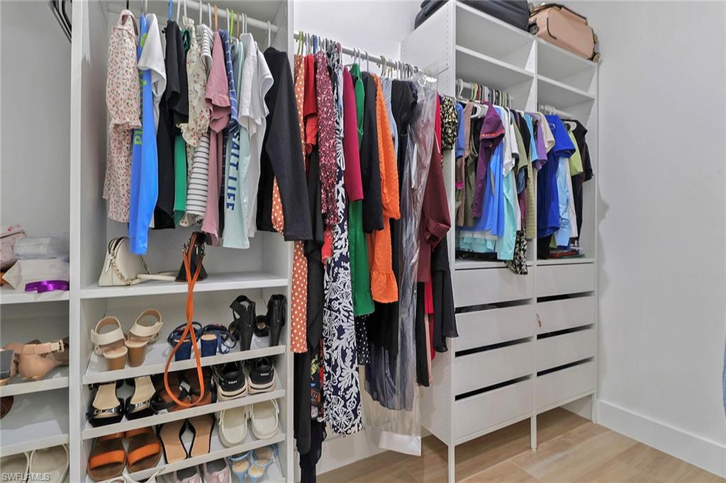 3748 Everglades Boulevard North Naples, FL 34120 - Photo 23 of 49 a view of walk in closet with clothes and shoes