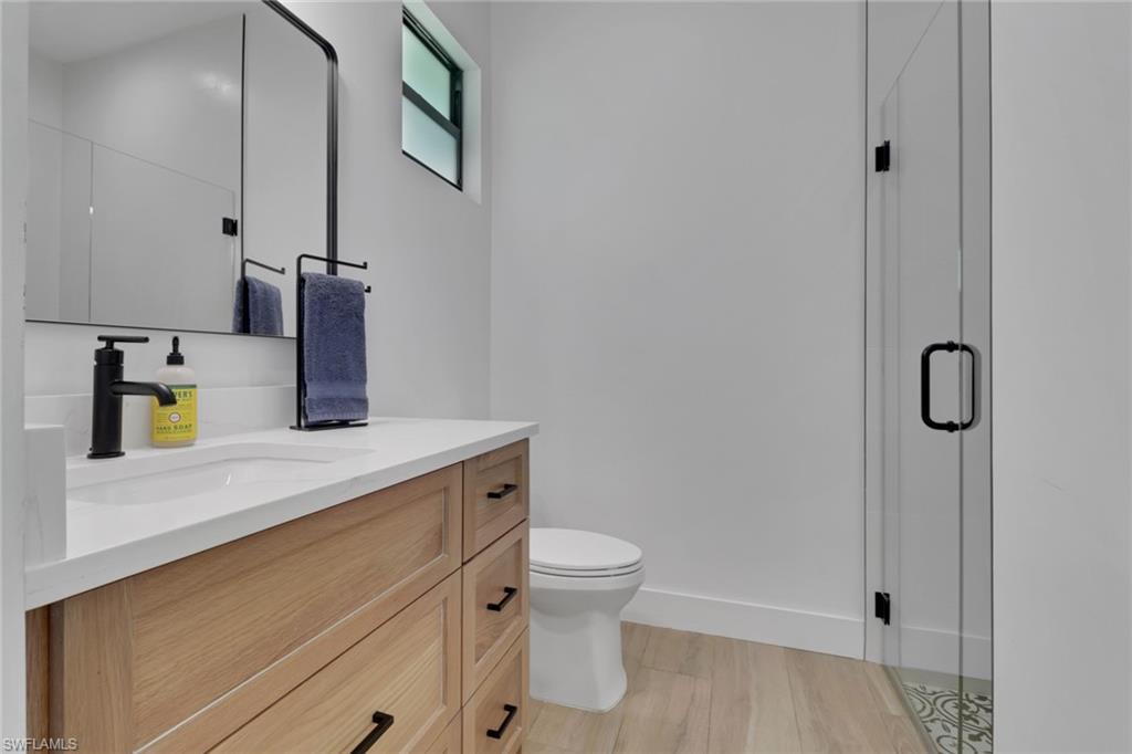 3748 Everglades Boulevard North Naples, FL 34120 - Photo 27 of 49 a bathroom with a sink a toilet and mirror