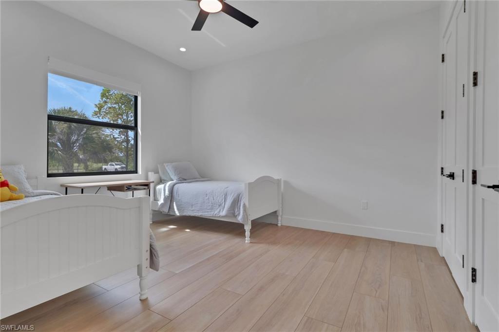 3748 Everglades Boulevard North Naples, FL 34120 - Photo 29 of 49 a bedroom with a bed and a painting on the wall