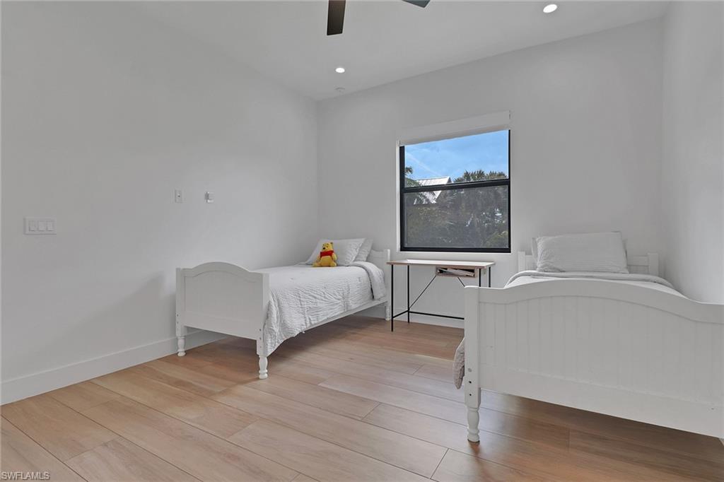 3748 Everglades Boulevard North Naples, FL 34120 - Photo 30 of 49 a bedroom with a bed and a table