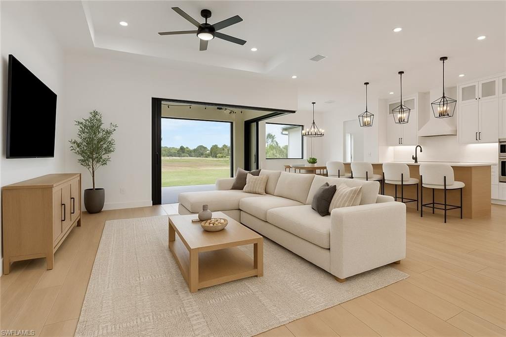 3748 Everglades Boulevard North Naples, FL 34120 - Photo 3 of 49 a living room with furniture and a flat screen tv