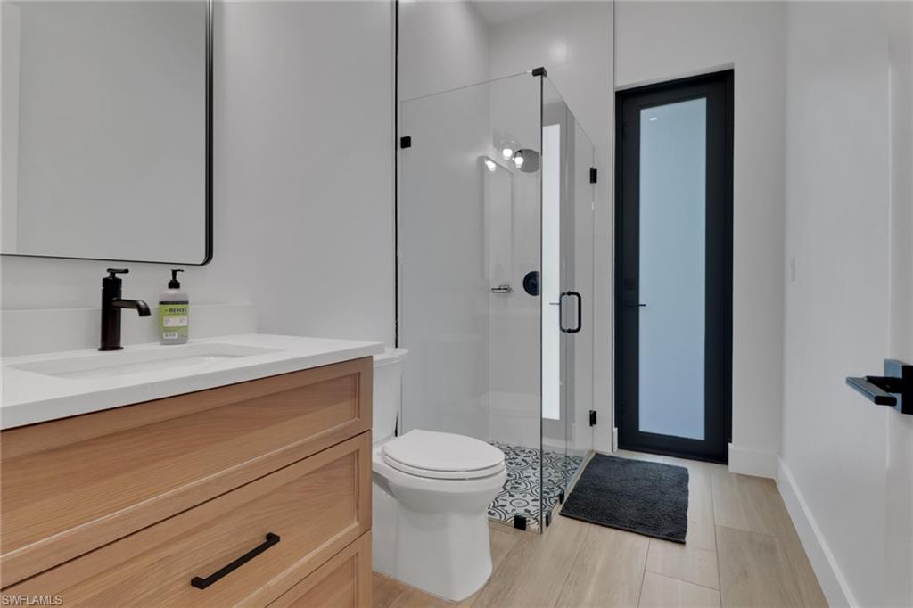 3748 Everglades Boulevard North Naples, FL 34120 - Photo 31 of 49 a bathroom with a sink a toilet and shower