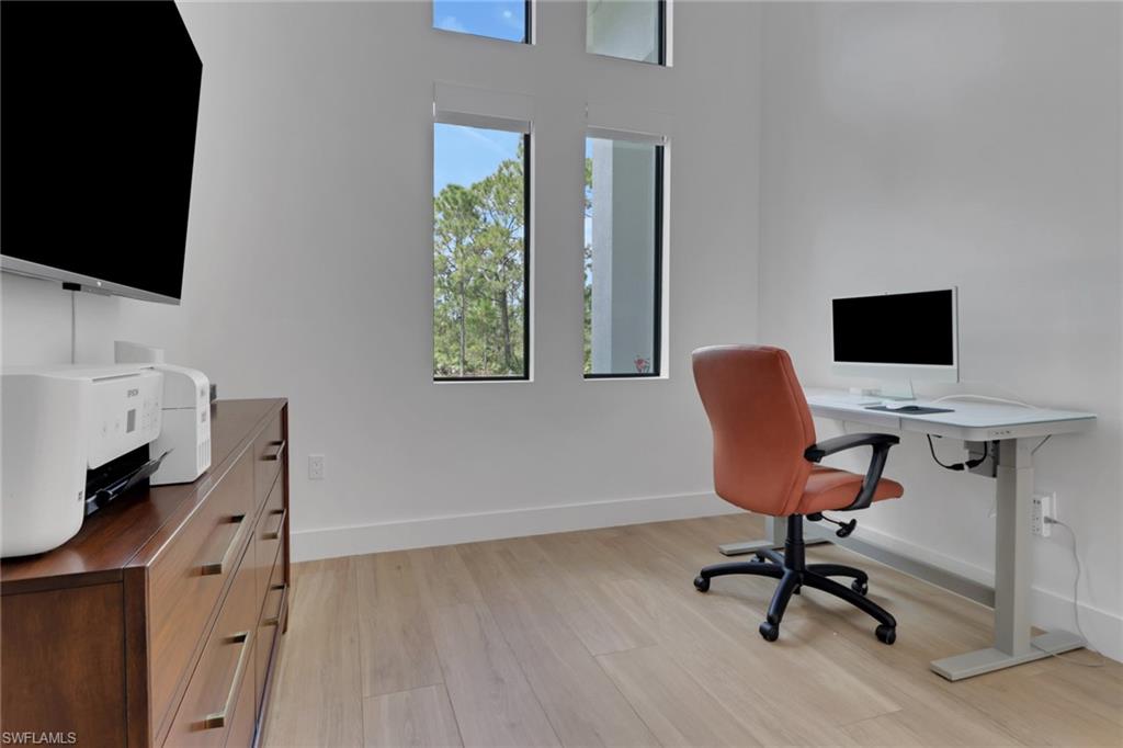 3748 Everglades Boulevard North Naples, FL 34120 - Photo 32 of 49 a view of a workspace with furniture and a window