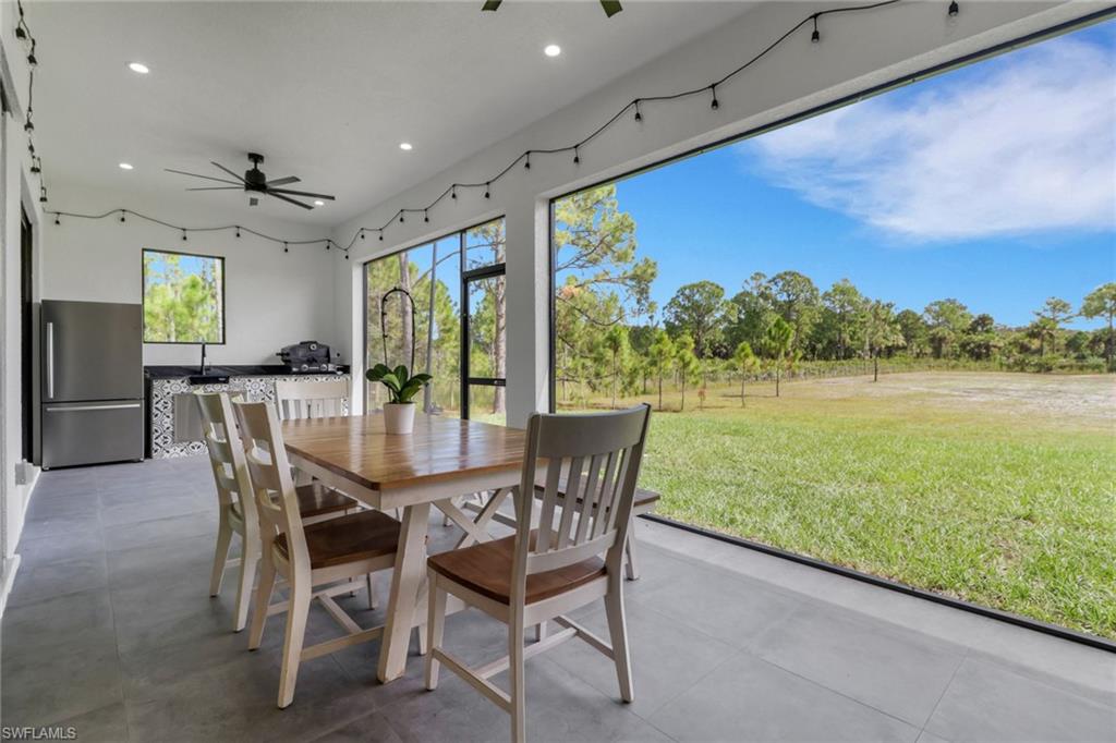 3748 Everglades Boulevard North Naples, FL 34120 - Photo 34 of 49 a dining room with furniture and a floor to ceiling window