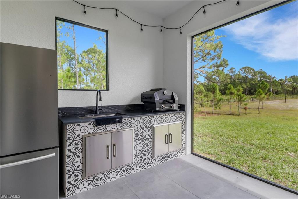 3748 Everglades Boulevard North Naples, FL 34120 - Photo 36 of 49 a kitchen with a sink and a large window