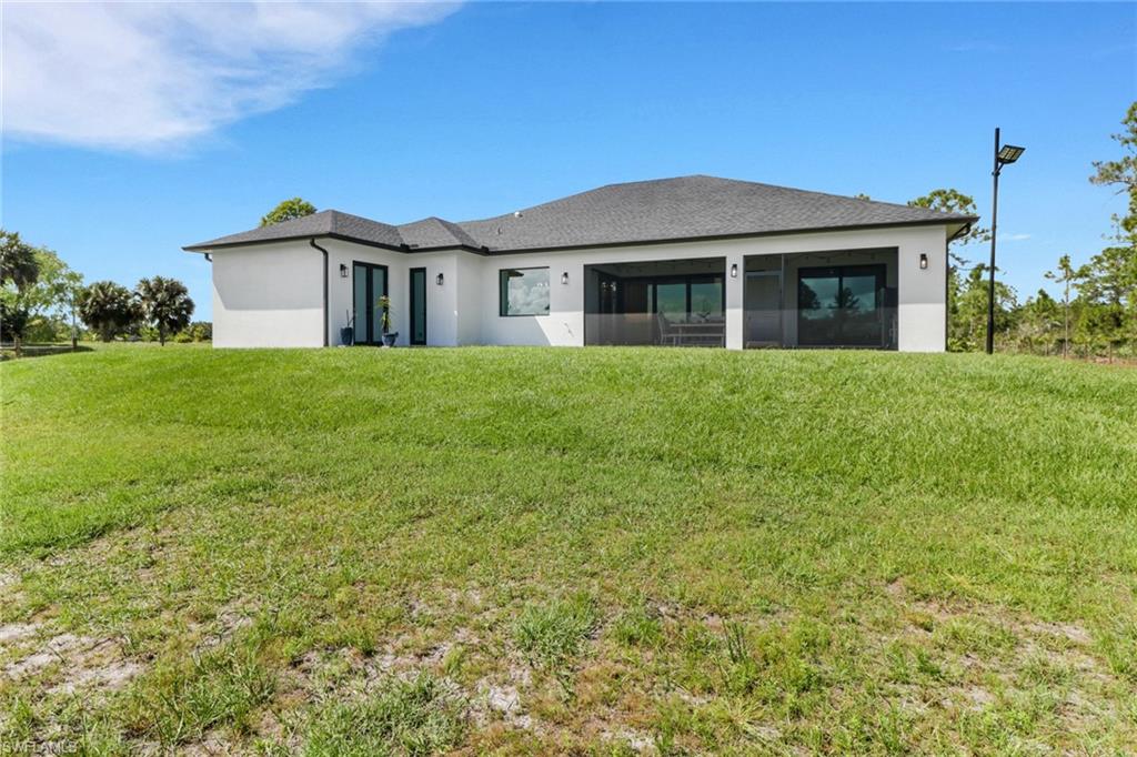 3748 Everglades Boulevard North Naples, FL 34120 - Photo 37 of 49 a front view of a house with a garden