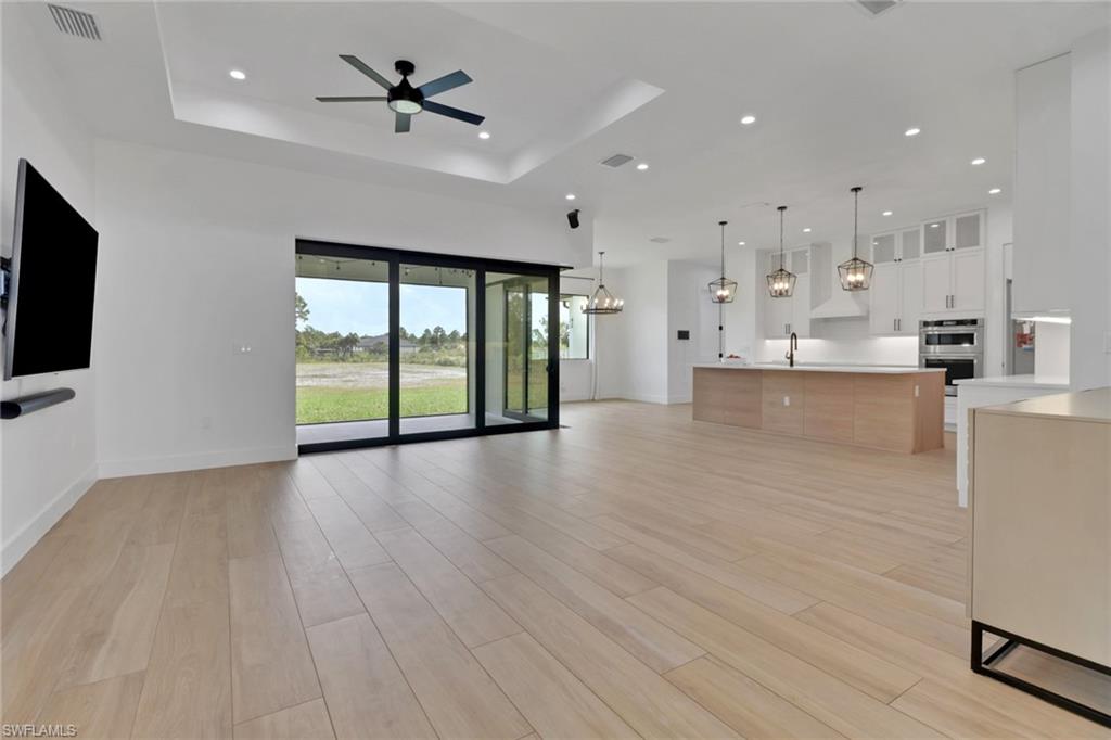 3748 Everglades Boulevard North Naples, FL 34120 - Photo 5 of 49 a view of an empty room with wooden floor and a window