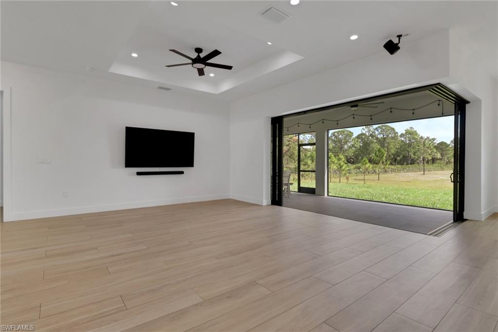 3748 Everglades Boulevard North Naples, FL 34120 - Photo 6 of 49 a view of empty room with wooden floor and fan