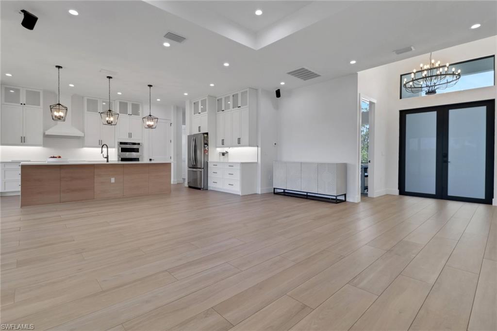 3748 Everglades Boulevard North Naples, FL 34120 - Photo 9 of 49 a large kitchen with stainless steel appliances a large counter top a stove a refrigerator and a cabinets