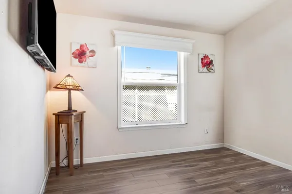 an empty room with wooden floor and cabinets