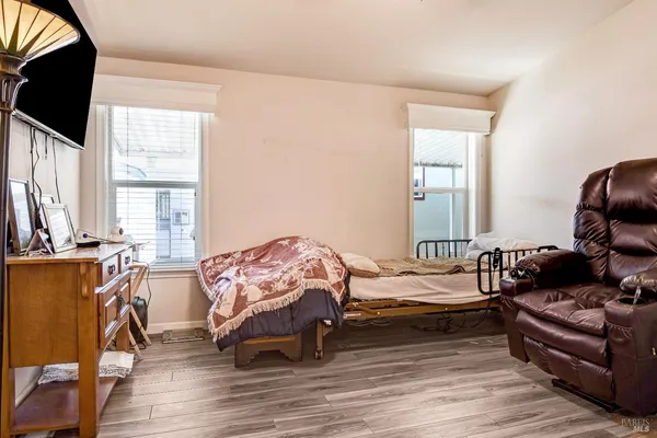 a bedroom with furniture and a window
