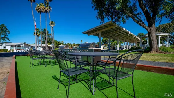 a view of an chairs and table in patio