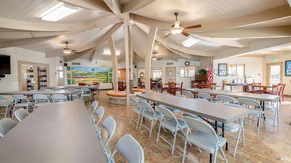 a very nice looking dining room with lots of furniture and a chandelier