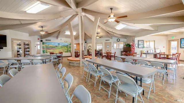 a very nice looking dining room with lots of furniture and a chandelier