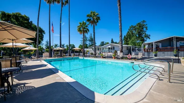 a view of a swimming pool with lounge chairs