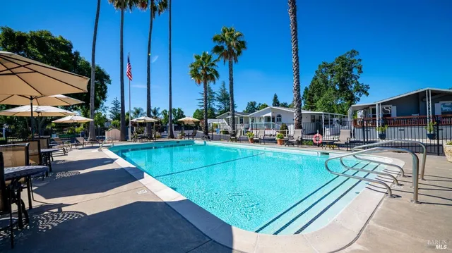 a view of a swimming pool with lounge chairs