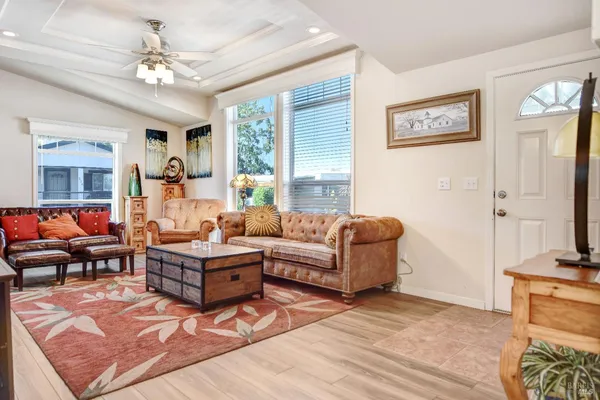 a living room with furniture flat screen tv and a window