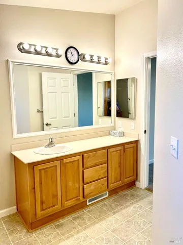 a bathroom with a sink and a large mirror