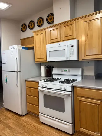 a kitchen with stainless steel appliances granite countertop a stove a refrigerator and a microwave