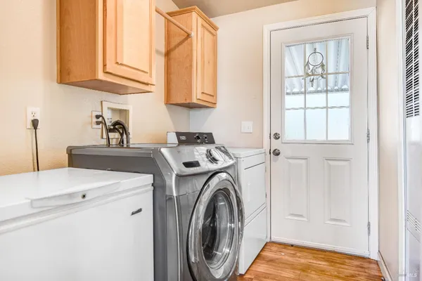 a utility room with sink dryer and washer