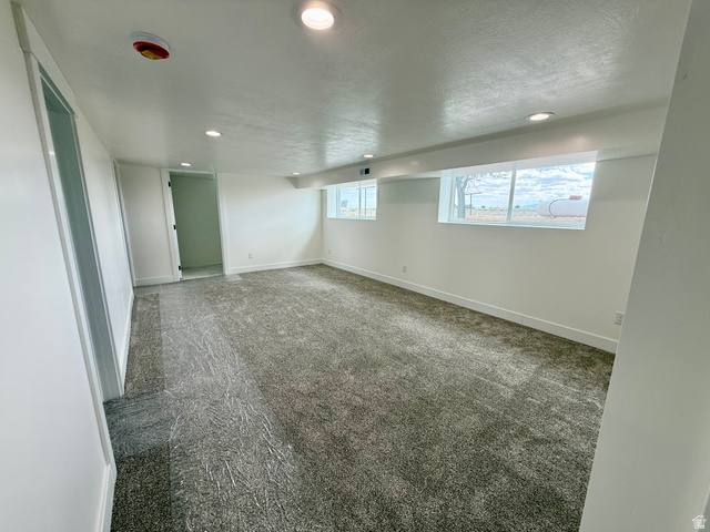 2865 North 3250 W Road Sutherland, UT 84624 - Photo 17 of 28 Spacious room with tan carpet flooring and white walls
