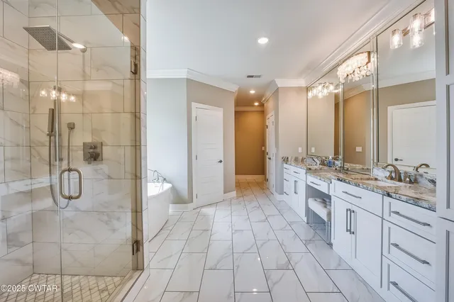 a bathroom with a double vanity sink mirror and shower
