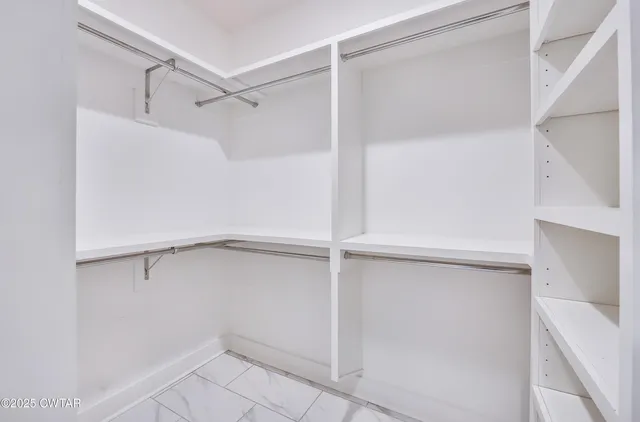 a view of an empty walk in closet