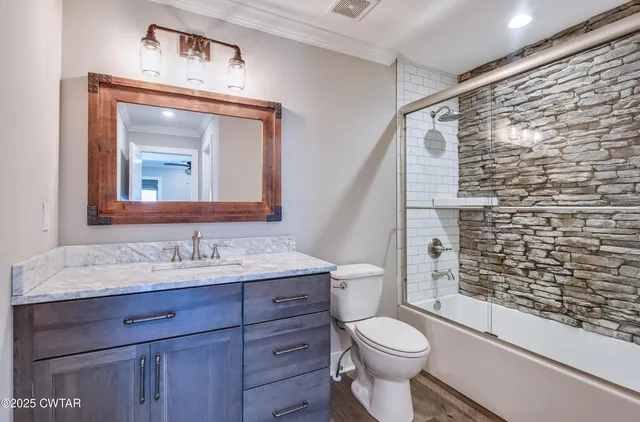 a bathroom with a toilet a sink and a shower