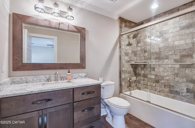 a bathroom with a toilet a sink and a mirror