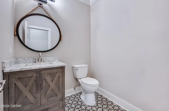 a bathroom with a toilet a sink and a mirror