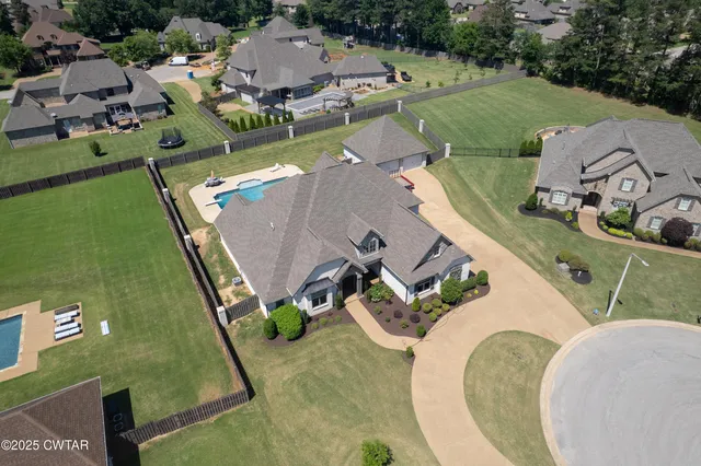 an aerial view of a house with a swimming pool