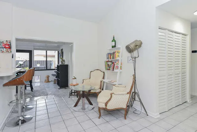 a view of a dining room with furniture large windows and wooden floor
