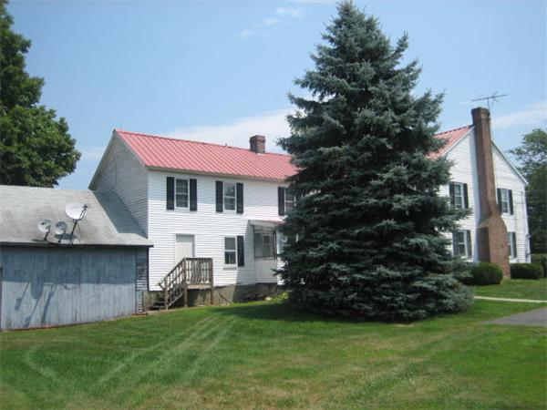 154 Long Plain Road Leverett, MA 01054 - Photo 3 of 16 a front view of a house with a garden and plants