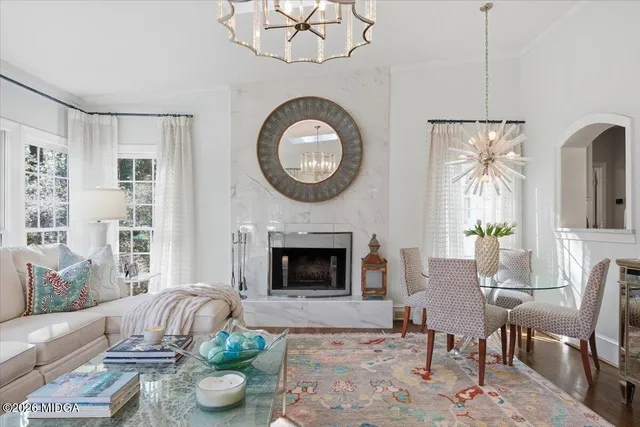 a living room with furniture a rug and a chandelier